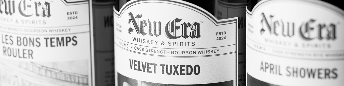 New Era Whiskey bottles including Velvet Tuxedo in a monochrome media-kit photograph.